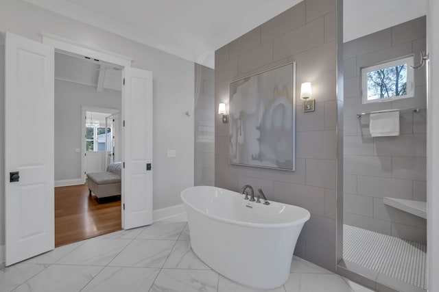 bathroom with shower with separate bathtub, hardwood / wood-style flooring, and tile walls