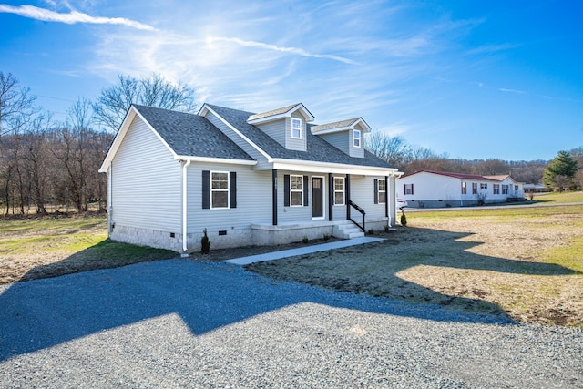 cape cod home with crawl space, covered porch, roof with shingles, and gravel driveway