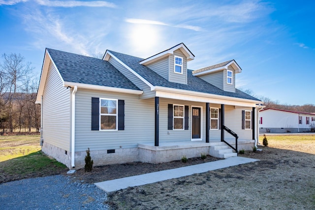 cape cod house featuring roof with shingles, a porch, and crawl space