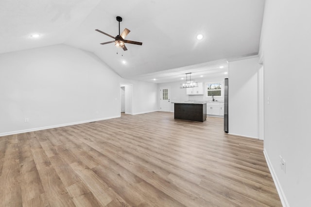 unfurnished living room with vaulted ceiling, recessed lighting, a ceiling fan, and light wood-style floors