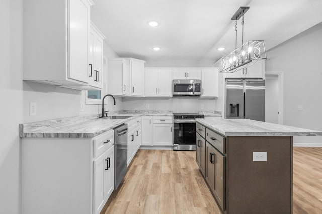 kitchen featuring white cabinets, stainless steel appliances, and a sink