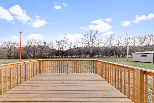 wooden deck with a storage unit and an outbuilding