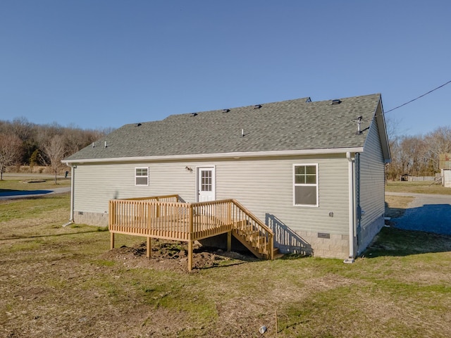 rear view of house featuring a shingled roof, crawl space, a lawn, and a deck