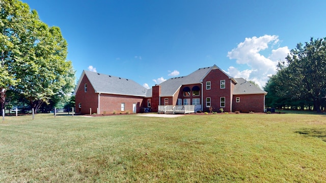 rear view of property with a yard