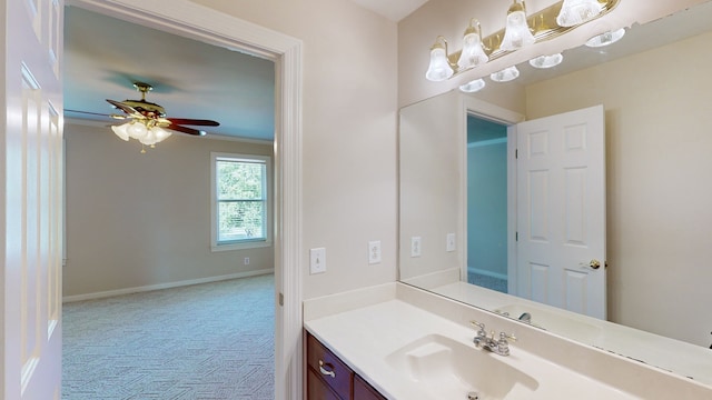 bathroom featuring ornamental molding, ceiling fan, and vanity