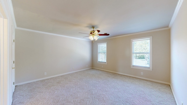 spare room with light carpet, crown molding, and a healthy amount of sunlight