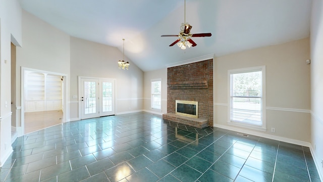 unfurnished living room with dark tile patterned floors, a brick fireplace, and plenty of natural light