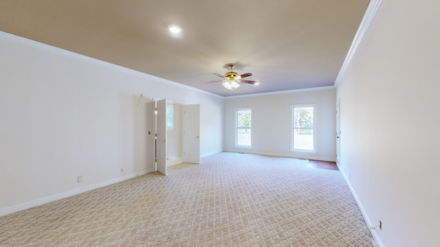 carpeted empty room featuring ornamental molding and ceiling fan