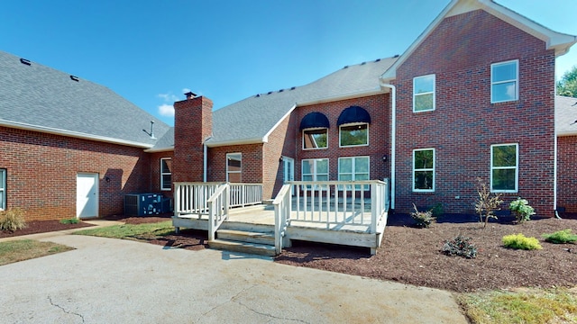 rear view of property with a wooden deck