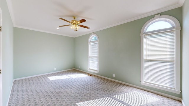 carpeted spare room featuring ornamental molding and ceiling fan