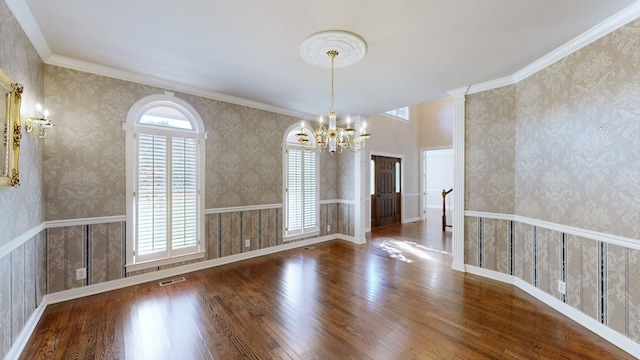 unfurnished dining area with an inviting chandelier, crown molding, and dark hardwood / wood-style flooring