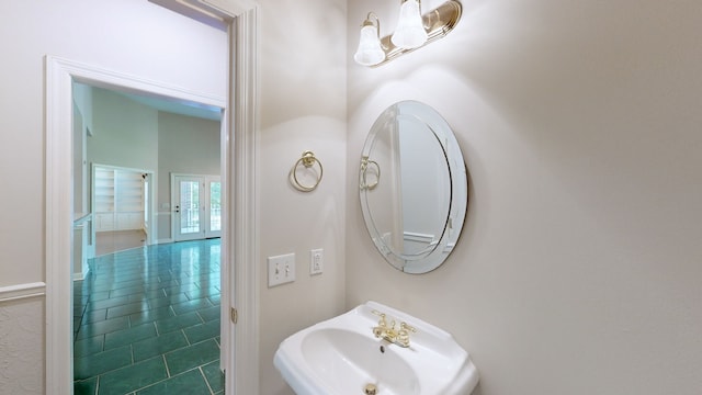 bathroom featuring tile patterned flooring, sink, and french doors