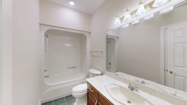 full bathroom featuring washtub / shower combination, vanity, toilet, and tile patterned floors