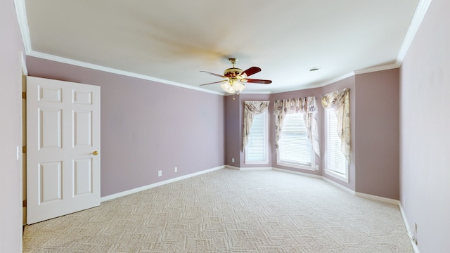 spare room with light carpet, ornamental molding, and ceiling fan