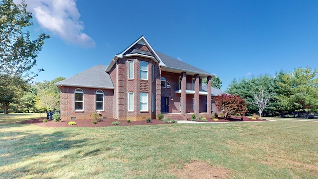 view of front of property with a balcony and a front yard