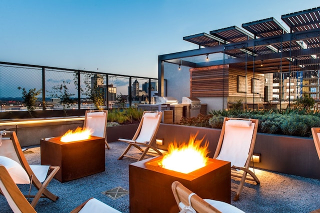 patio terrace at dusk with a pergola and an outdoor fire pit