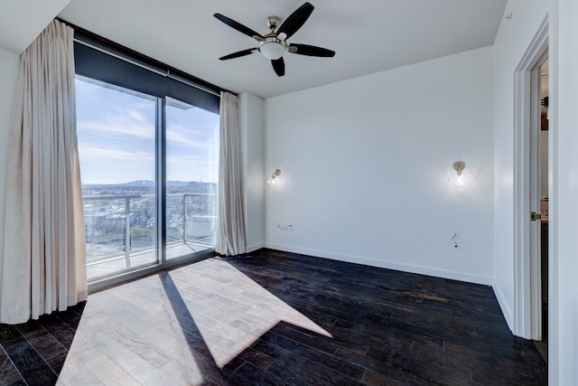 spare room featuring ceiling fan and dark hardwood / wood-style flooring