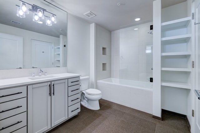 full bathroom featuring vanity, tiled shower / bath, and toilet