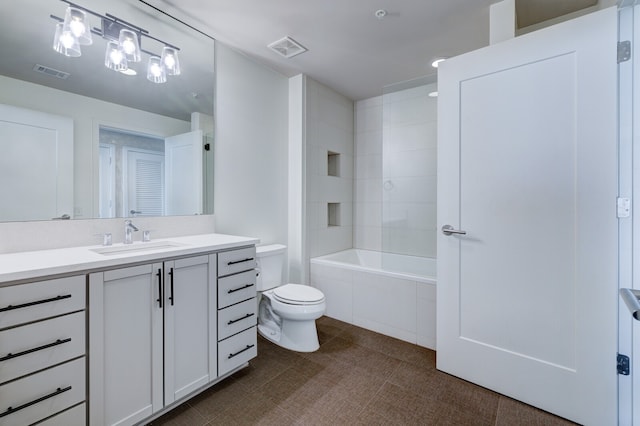 full bathroom with vanity, toilet, and tiled shower / bath