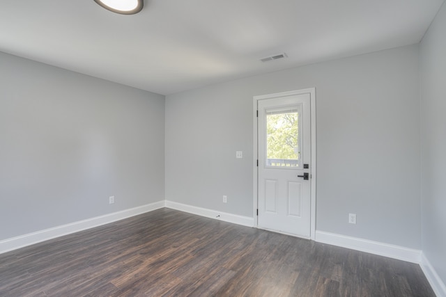 empty room with dark wood-type flooring