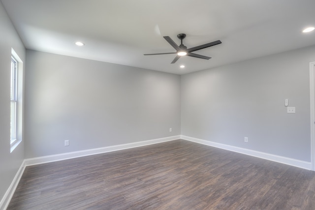 unfurnished room with ceiling fan and dark hardwood / wood-style flooring