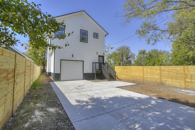 back of house featuring a garage