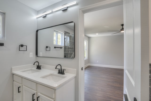 bathroom featuring wood-type flooring, vanity, and ceiling fan