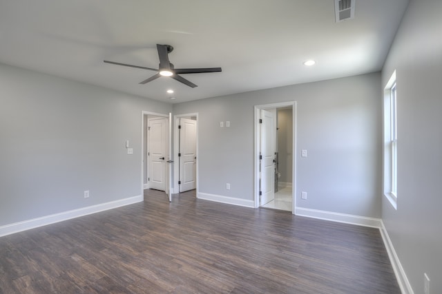 unfurnished bedroom featuring dark hardwood / wood-style floors, connected bathroom, and ceiling fan