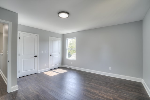 unfurnished bedroom featuring dark wood-type flooring