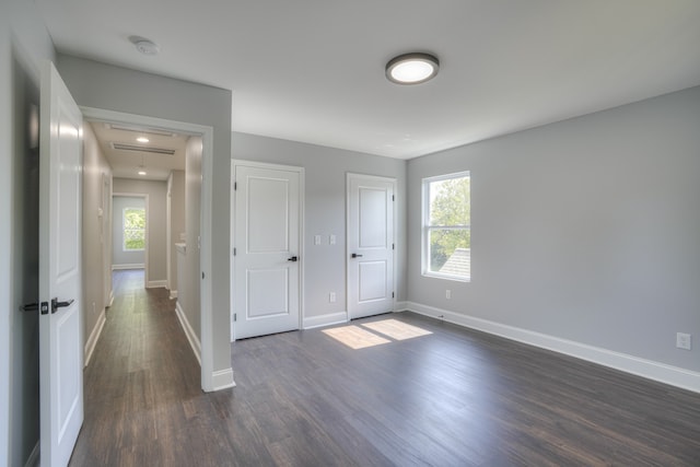 unfurnished bedroom with dark wood-type flooring