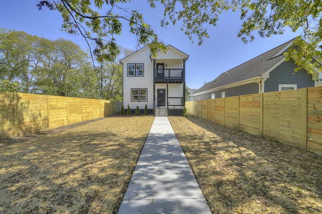 rear view of property featuring a balcony