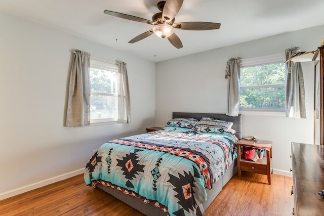 bedroom with hardwood / wood-style floors and ceiling fan