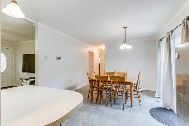 carpeted dining area with ornamental molding and a notable chandelier