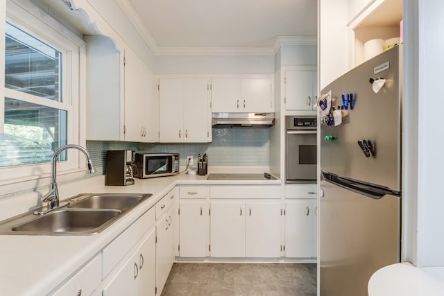 kitchen with white cabinetry, tasteful backsplash, stainless steel appliances, crown molding, and sink