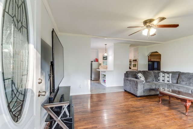 living room with ornamental molding, ceiling fan, and hardwood / wood-style flooring