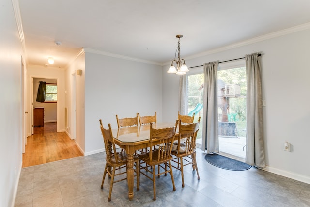 dining space featuring crown molding, an inviting chandelier, and a wealth of natural light