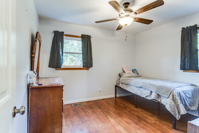 bedroom with ceiling fan and hardwood / wood-style floors