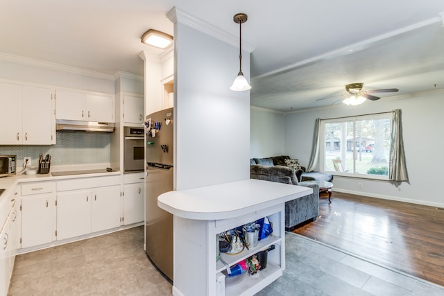 kitchen featuring hanging light fixtures, light hardwood / wood-style floors, white cabinetry, and stainless steel appliances