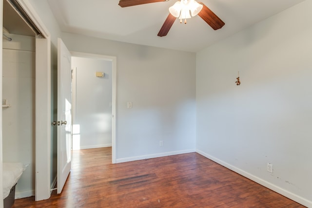 spare room with ceiling fan and dark hardwood / wood-style flooring