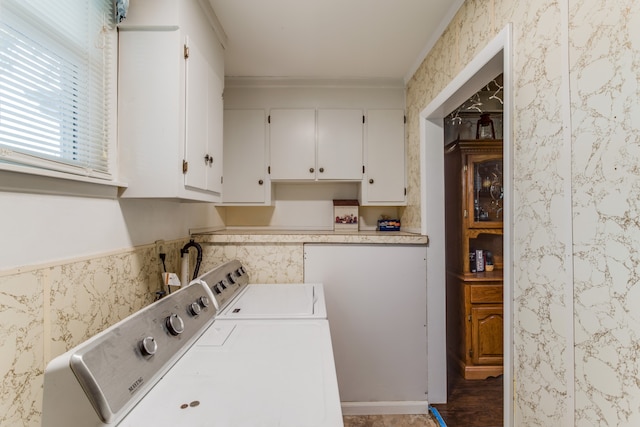 washroom with crown molding, washing machine and dryer, dark wood-type flooring, and cabinets