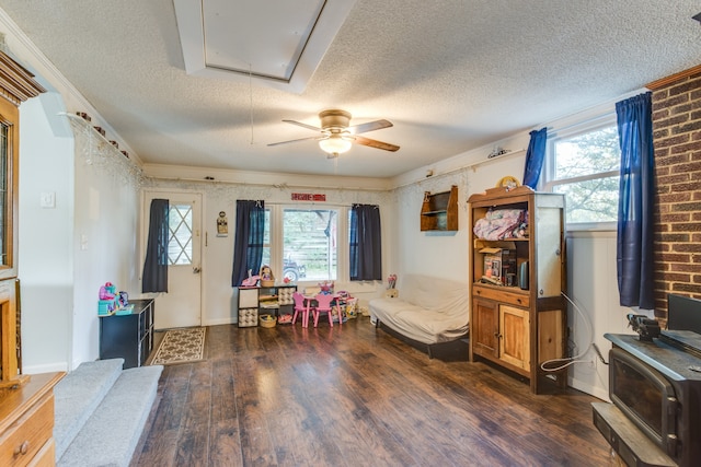 interior space featuring a textured ceiling, crown molding, ceiling fan, and dark hardwood / wood-style flooring