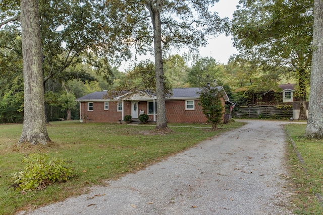 ranch-style home featuring a front yard