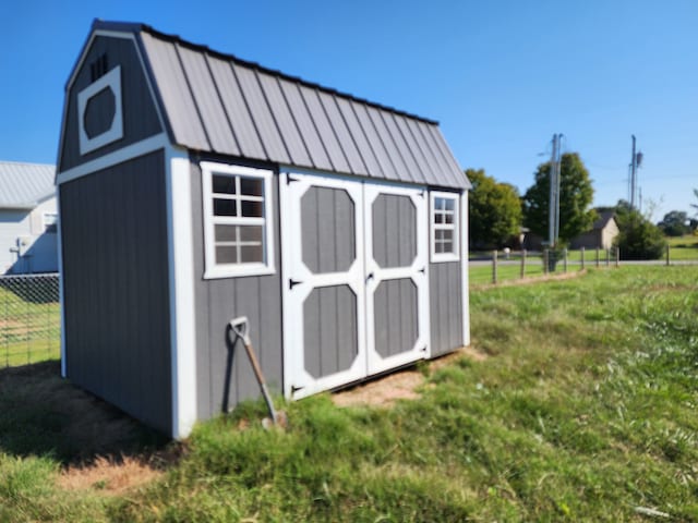 view of outbuilding featuring a lawn