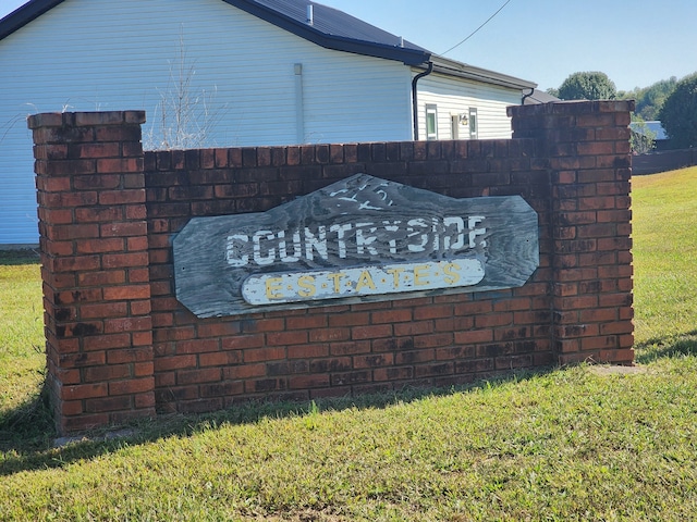 community / neighborhood sign with a yard