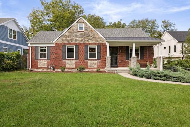 view of front of house featuring a front lawn and covered porch