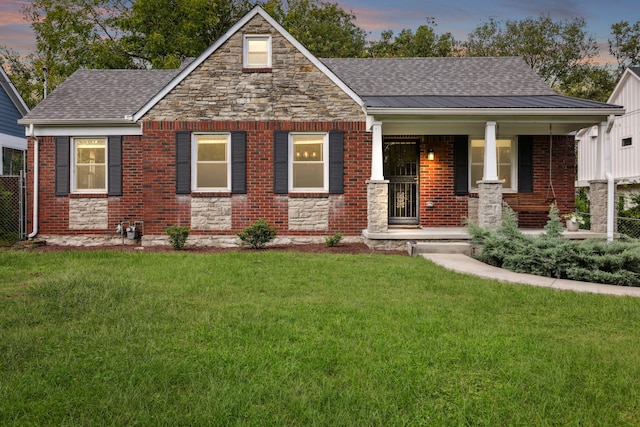 view of front of property featuring a lawn and a porch