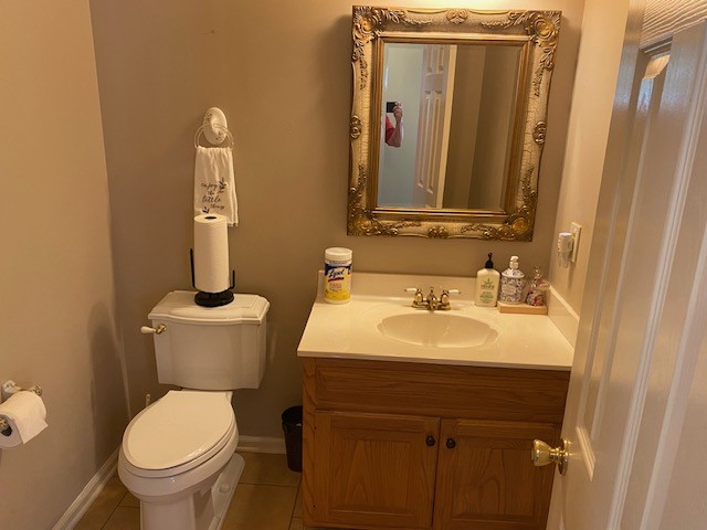 bathroom featuring vanity, toilet, and tile patterned floors