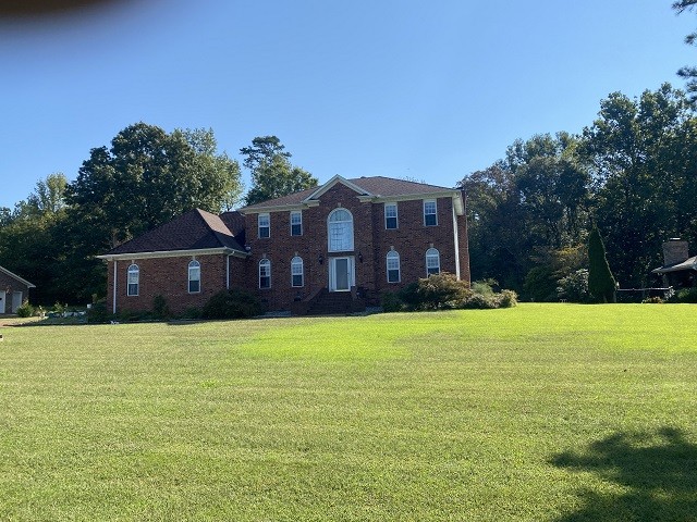 colonial home with a front lawn