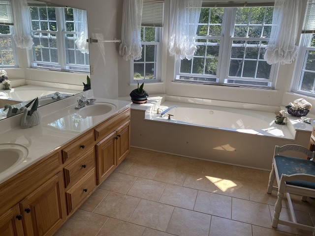 bathroom with vanity, tile patterned flooring, and a tub