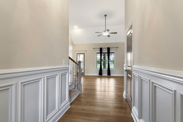 corridor featuring light hardwood / wood-style flooring and high vaulted ceiling